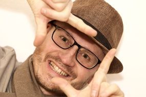 portrait of a man with glasses and a hat