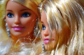 two Barbie dolls are close together