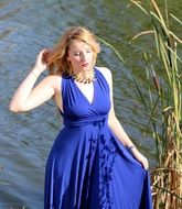 nice woman in blue dress by the lake