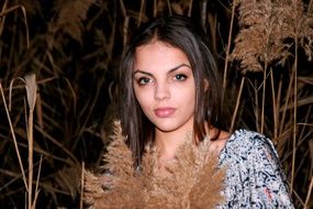 girl at a photo shoot near a reed In the dark