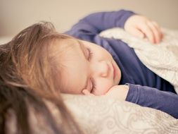 baby girl asleep in bed