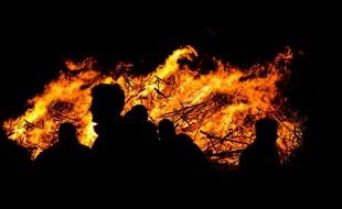 People as silhouettes are Watching Fire