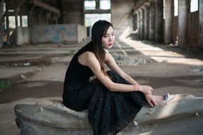 asian model in black dress in the abandoned factory