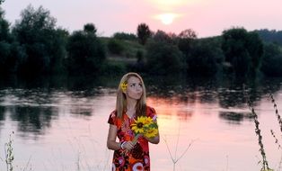blonde with sunflower bouquet in the evening