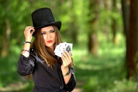 beautiful girl with playing cards in the park