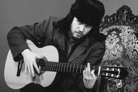 guitarist with his guitar on the couch