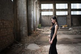girl in a black dress in an abandoned building