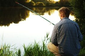fisher with angler on the lakeside