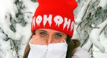 portrait of a beautiful girl with blue eyes among the winter landscape