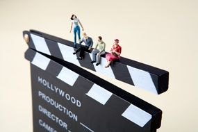 figures of people on clapper board numbering