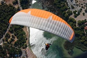 paragliding over a picturesque landscape on a sunny day
