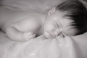 baby sleeping on the bed