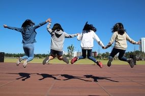 four jumping girls