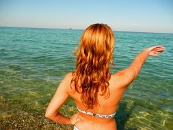 Girl on the vacation in summer near the water