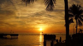 sailboats on the ocean horizon at sunset