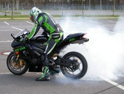 motorcyclist on a motorcycle with steaming tires