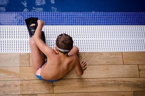 boy in the pool with fins on his feet