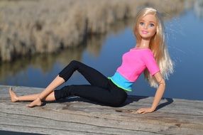 barbie doll on a wooden pier