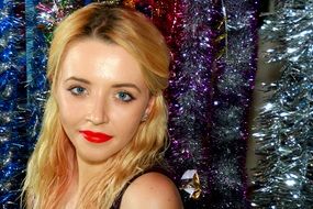 portrait of a blonde against the background of festive tinsel