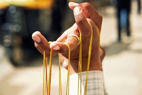 thin ropes on male fingers, india