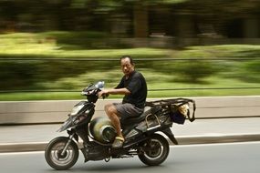 asian man riding a motorcycle