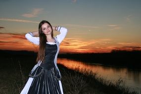 girl like a princess among nature at sunset