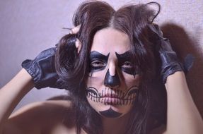 brunette with drawing on the face and gloves