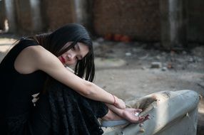 thoughtful asian model in the abandoned plant