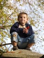 child on a dais among the autumn landscape