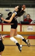 Girl bounces in volleyball