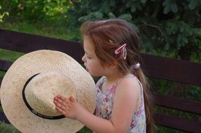 little girl on a park bench