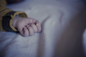 photo of hand of a sleeping baby