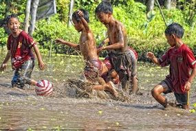 children play in the river in Indonesia