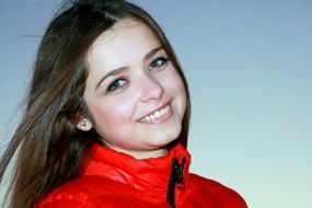 Beautiful smiling long haired Girl in Red jacket