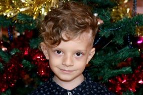 cute caucasian boy at Christmas Tree, head portrait