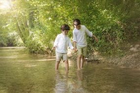children go on the river at the sunlight
