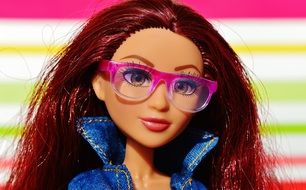 a beautiful doll in glasses with a pink rim