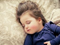 baby girl sleeping on the bed