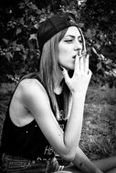 black and white photo of a smoking girl