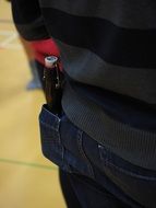 bottle in the back pocket of jeans