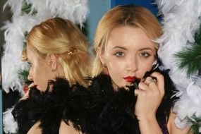 portrait of a blonde in black feathers