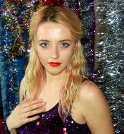 portrait of a blonde haired girl in dress with tinsels