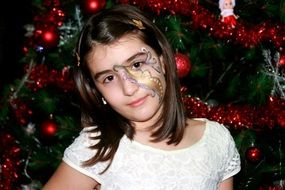 girl in aqua makeup in christmas tinsel