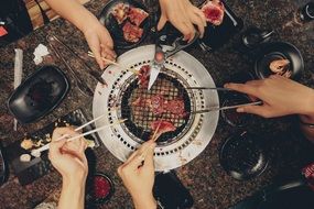friends gathered at the family grill