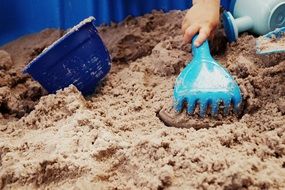 child is playing in the sand