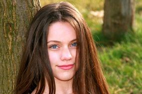 Nice Girl with Blue Eyes at Tree