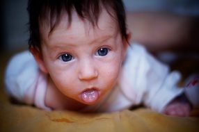 little baby shows tongue
