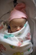 Sleeping Newborn Baby in pink hat