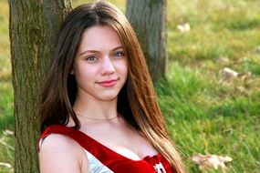 portrait of a girl with long hair near a tree