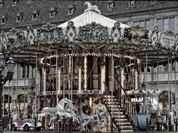 black and white photo of a children's carousel